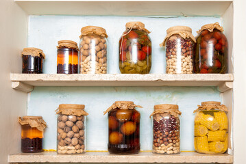 Rustic pantry shelf with preserved food jars.