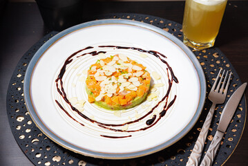 Salmon tartare with avocado and almond flakes.