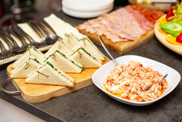 Catering setup with finger sandwiches and spreads.
