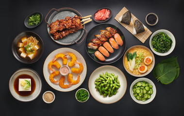 Japanese food, asian cuisine, a set of assorted dishes top view, flat lay, Chicken Yakitori, Smoked Eel and Salmon Sushi, Ramen, Miso Soup, Spinach Gomaae, Tempura Shrimp, Onigiri, Hiyayakko 