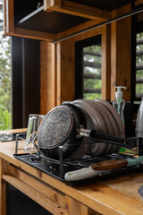 Plates neatly drying on a dish rack inside a warm, rustic kitchen, showcasing simple, homey living with natural wood elements and soft, inviting light.

