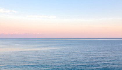 Fototapeta premium Calm ocean horizon at sunrise with gentle waves and soft pastel sky reflecting tranquility and peace
