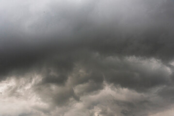Dramatic dark storm thundercloud rain clouds on black sky background. Dark thunderstorm clouds rainny landscape. Meteorology danger windstorm disaster climate. Dark cloudscape storm disaster gray sky