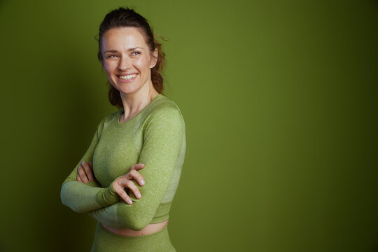 Fototapeta Self-assured woman in green athletic wear