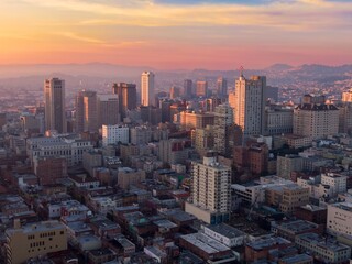 Aerial view of San Francisco, California, USA, at sunrise. The city's skyline is visible, with...
