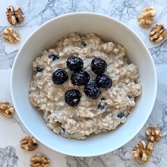 Oatmeal Bowl with Blueberries and Walnuts on Marble Tabletop for Healthy Breakfast