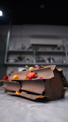 uncut chocolate roll cake topped with long chocolate chips and small fruits