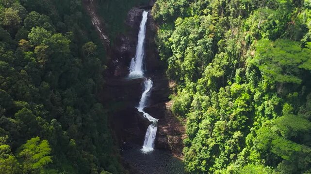 Aerial view of Waterfall in a tropical forest surrounded by green vegetation. Sri Pada Falls in mountain jungle. Maskeliya, Sri Lanka.