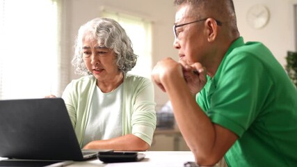 Old man and woman reviewing digital data on laptop with thoughtful expressions and teamwork spirit - Powered by Adobe