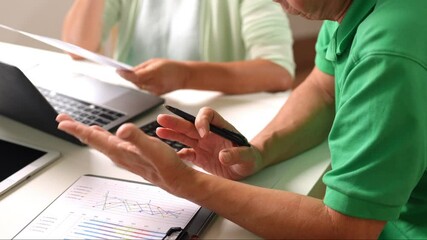 Hands of senior man holding phone and discussing graph data with partner during budget planning - Powered by Adobe