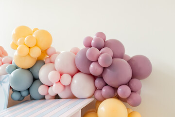 colorful balloon arch at baby girl's birthday party, room for copy