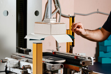 Efficiently wrapping rectangular boxes with a state-of-the-art semi-automatic machine in a bustling...
