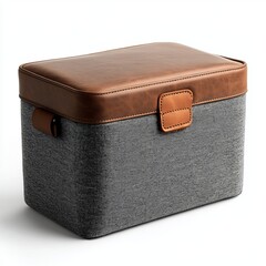 A rectangular storage box with a gray fabric body and a brown leather lid and handle, combining modern and classic design elements.