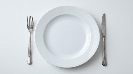 A silver fork and knife are on a white plate