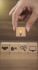 Wooden blocks with icons; the key stages of the design thinking process, a solution-focused, problem-solving methodology used for innovation and strategic development. Design Thinking Process concept.