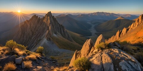 Obraz premium Panoramic Mountain Range Sunrise Landscape with Golden Light and Rugged Peaks