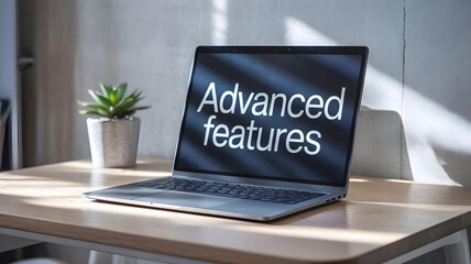 Modern Laptop Displaying &ldquo;Advanced Features&rdquo; on Contemporary Desk with Green Plant &ndash; Software Innovation and Productivity Concept
