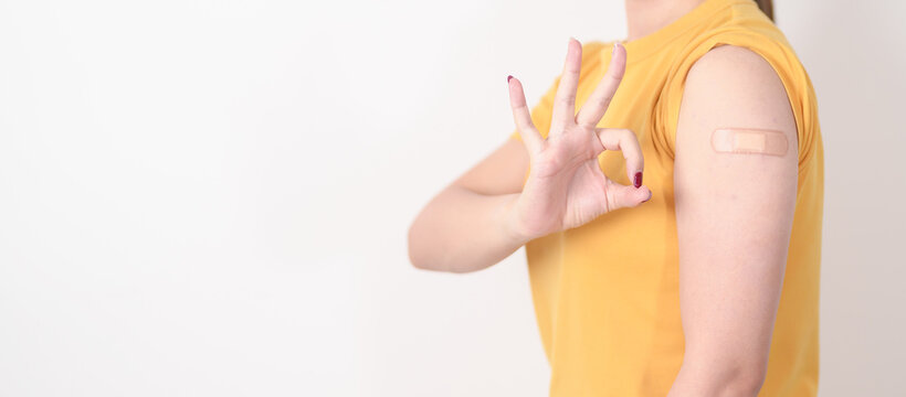 Adult Woman with bandage after received vaccine. Vaccination and Immunization for Influenza, HPV, Zoster, IPD, DTP or Diphtheria, Tetanus and Pertussis, MMR, Hepatitis B, Covid and Varicella vaccine