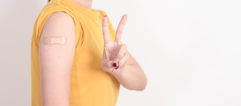 Adult Woman with bandage after received vaccine. Vaccination and Immunization for Influenza, HPV, Zoster, IPD, DTP or Diphtheria, Tetanus and Pertussis, MMR, Hepatitis B, Covid and Varicella vaccine