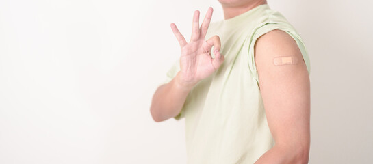 Adult Man with bandage after received vaccine. Vaccination and Immunization for Influenza, HPV,...