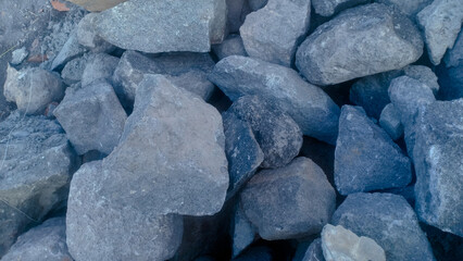 Natural river stones used for building foundations. These sturdy and durable rocks provide strong structural support and are commonly used in traditional and modern construction projects.