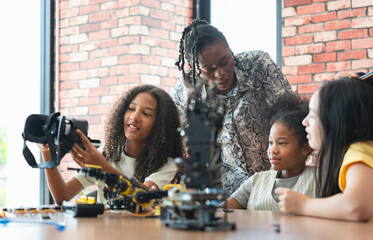 Girls Engaged in STEM Learning with Robotics and VR, Diverse Students and Teacher Exploring Technology and Engineering, Young Innovators Building and Learning with Robotics