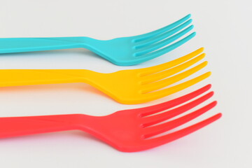 colorful fork isolated on white background, plastic cutlery for picnic