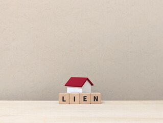 mini house with the word Lien on wooden block. Property and real estate concept. building, object