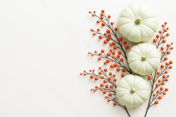 White pumpkins and orange berries arranged on light background for autumn food and seasonal decoration concept with copy space on left.