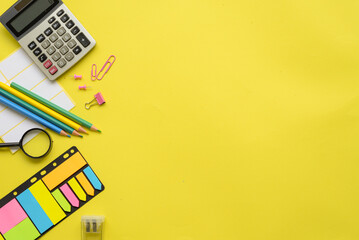 An Array of Colorful Office Supplies Laid Out on a Bright Yellow Background for Inspiration