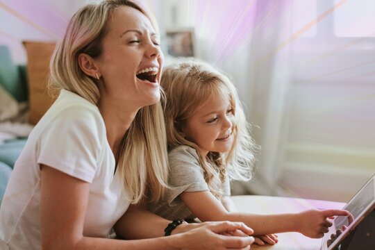 Mom and daughter watching a cartoon on a digital tablet