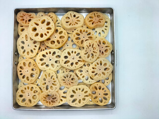 Lotus roots are washed, peeled and thinly sliced, ready to be made into sweet lotus root dessert, a...