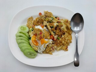 Salted egg omelet surrounded by minced pork omelet creative menu Combining ingredients from food preservation to enhance flavor and using common ingredients. Decorate the plate with cucumbers.