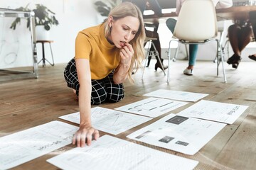 Casual businesswoman planning project on floor