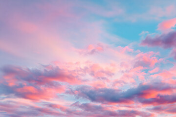a plane flying through a cloudy sky with a pink and blue sky