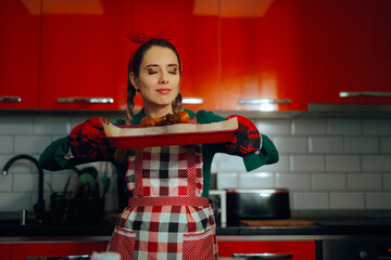 Woman Takes a Tray Out of the Oven That Smells Delicious. Housewife getting ready for holiday celebration making traditional dish