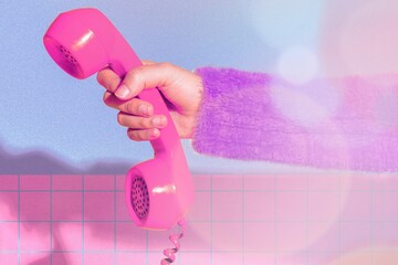 Hand holding pink retro phone, colorful design