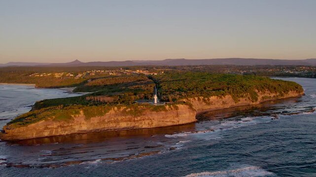 Warden Head Lighthouse rises above rocky cliffs and open ocean near Ulladulla, NSW. Captured by drone, this coastal view highlights Australia&rsquo;s wild landscape and tourism charm.