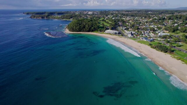 Cinematic drone flyover of Mollymook Beach near Ulladulla, NSW. Crystal-clear water, long sandy shoreline, and gentle waves create a breathtaking aerial view of Australia&rsquo;s South Coast.