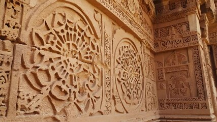 A close-up of intricate stone carving on an ancient structure, revealing detailed patterns and the rich artistry of historical civilizations. Ideal for history, culture, archaeology, or heritage theme