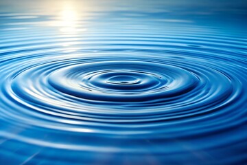 Abstract concentric ripples on blue water surface, sunlight reflection