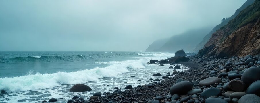 A misty, overcast day on a rocky shoreline Grey skies and churning waves create a dramatic, moody atmosphere Perfect for travel, nature, and weather-related projects , seascape, power, texture