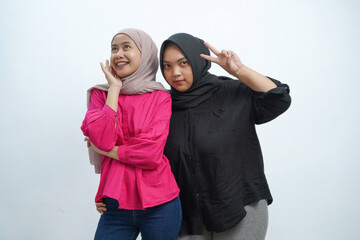 Joyful Indonesian Muslim Women Posing Together with Cute Gesture on White Background
