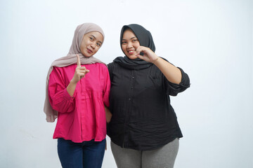 Happy Asian Indonesian Muslim Women Pointing Up and Smiling in Studio Portrait