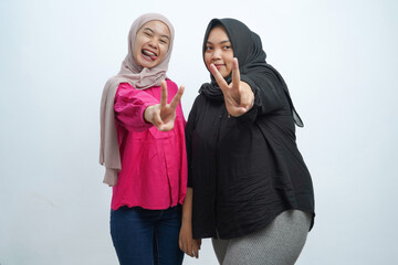 Happy Asian Indonesian Muslim Women Showing Peace Sign in Studio Portrait