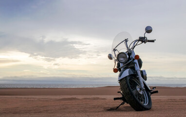 Off-road motorcycle standing still in the open desert beneath heavy clouds. A strong visual of freedom, rugged adventure, and the thrill of riding through wild, untamed terrain.