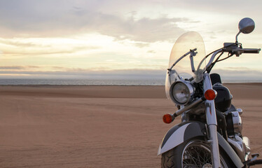 Off-road motorcycle standing still in the open desert beneath heavy clouds. A strong visual of freedom, rugged adventure, and the thrill of riding through wild, untamed terrain.