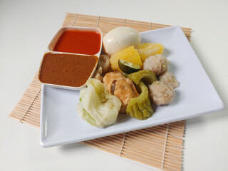 Siomay Bandung (Shumay) or steamed dumplings with boiled egg, tofu, potato, bitter melon and...