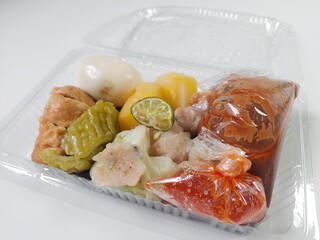 Siomay Bandung (Shumay) or steamed dumplings with boiled egg, tofu, potato, bitter melon, cabbage...