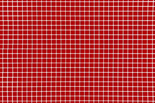 a red and white tiled wall with a white grid